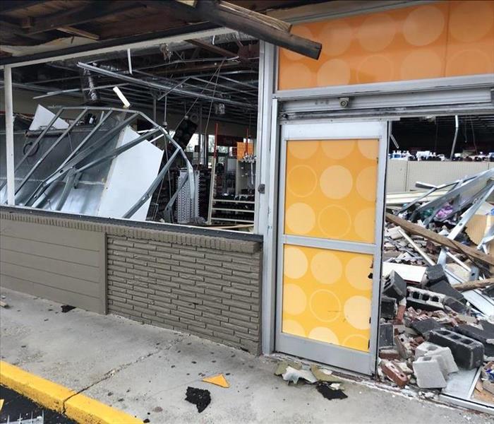 Front of business smashed in with debris